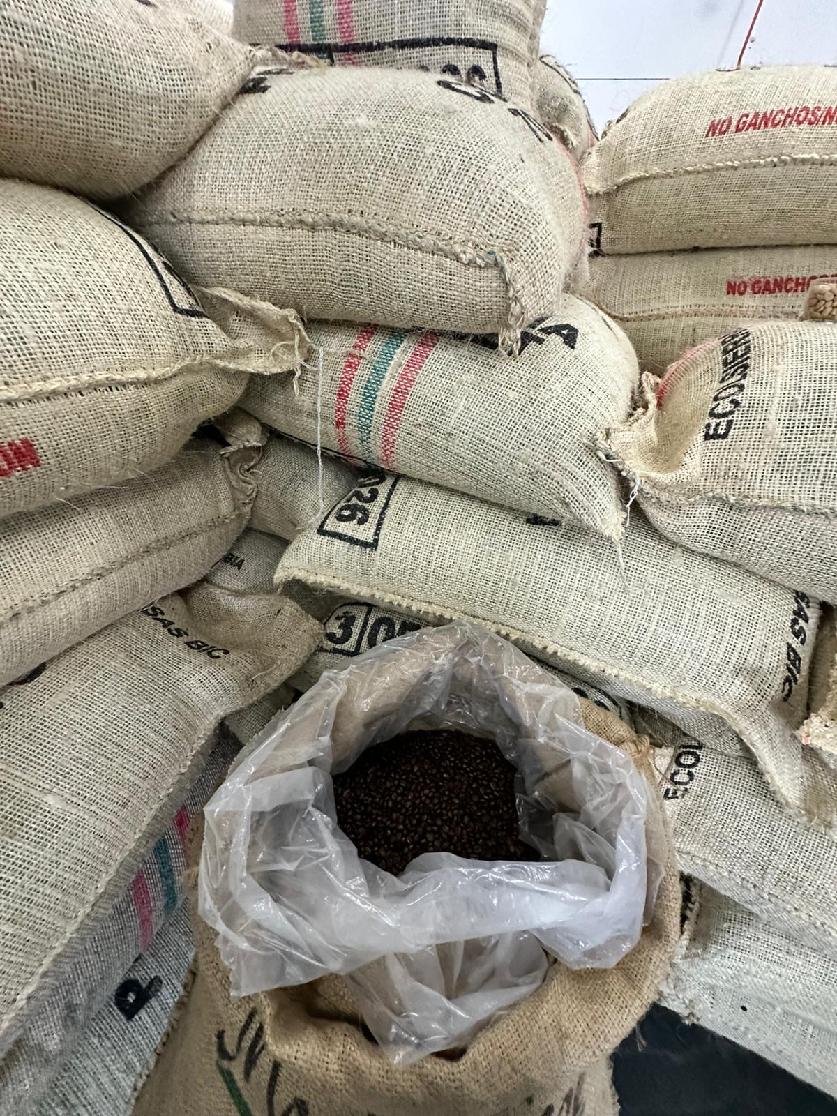 Open jute sack revealing coffee beans