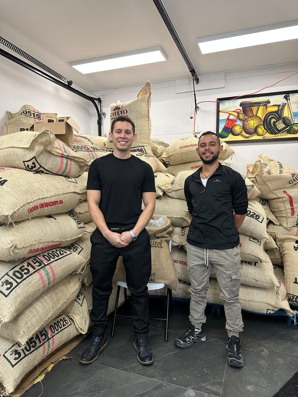 The CIFS CAFÉ team in front of Colombian green coffee sacks